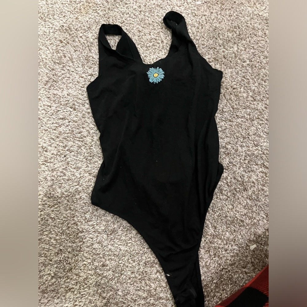 Black bodysuit with a blue flower in the middle